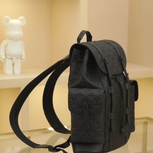 Alternative view of The Christopher Small Backpack in full-grain leather features embossed Monogram pattern Taurillon leather. Its moderate capacity combines exterior pockets with functional interior compartments, complemented by leather shoulder straps and matte metal hardware. Drawstring and snap closures securely protect your belongings. Dimensions: 32 x 39 x 12 cm.